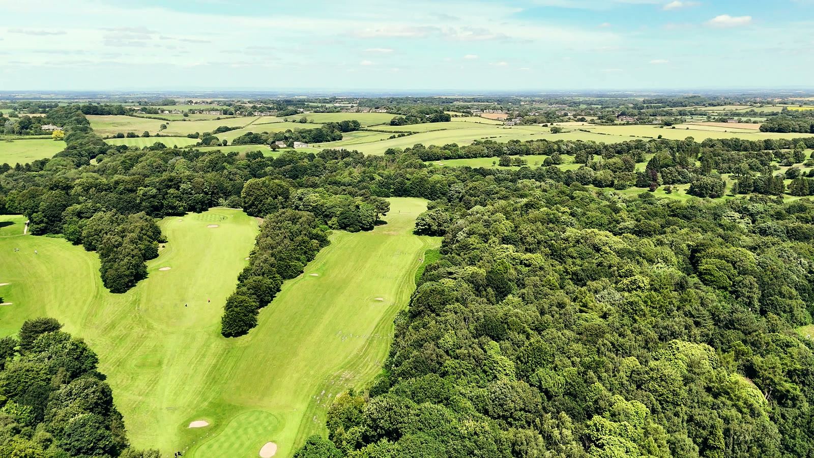 Tree-lined fairways running toward open Nottinghamshire countryside